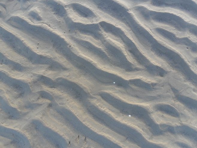 Close-up view of ripples in the sand at Flookburgh Bay.