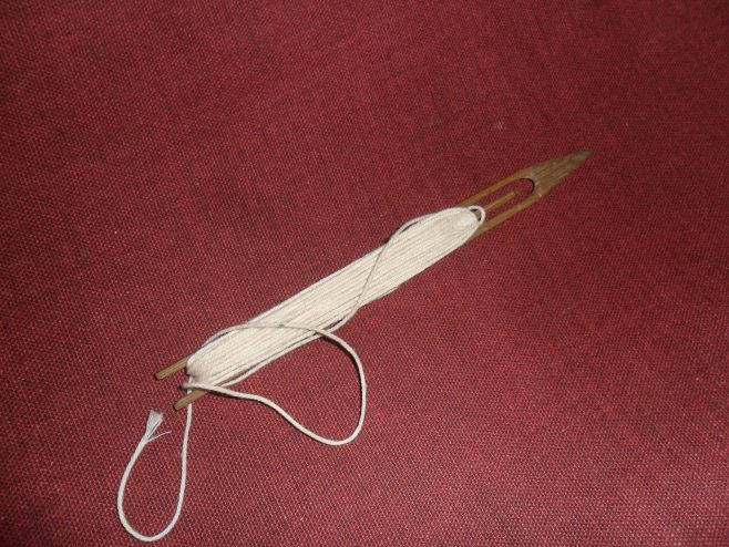 A netting needle or shuttle loaded with twine seen at the house of Ernie Nicholson, one of the oral history interviewees.