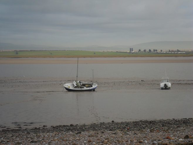 Two small fishing boats on the Lune estuary at Sunderland Point at low tide